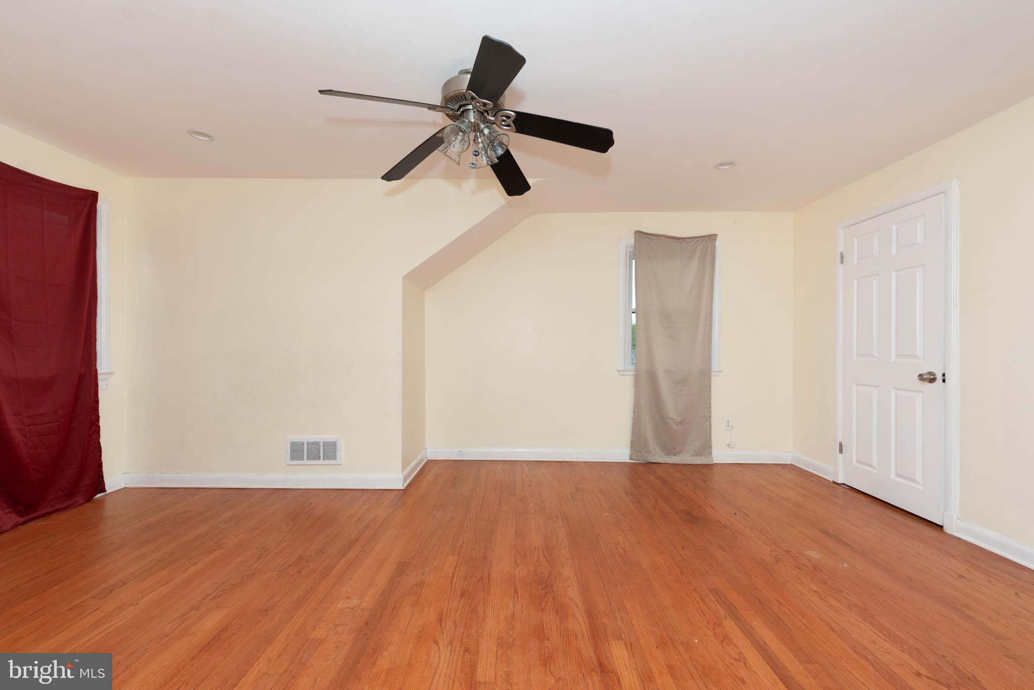 6702 Queens Ferry Road Baltimore, MD 21239 - Photo 17 of 40 a view of empty room with wooden floor