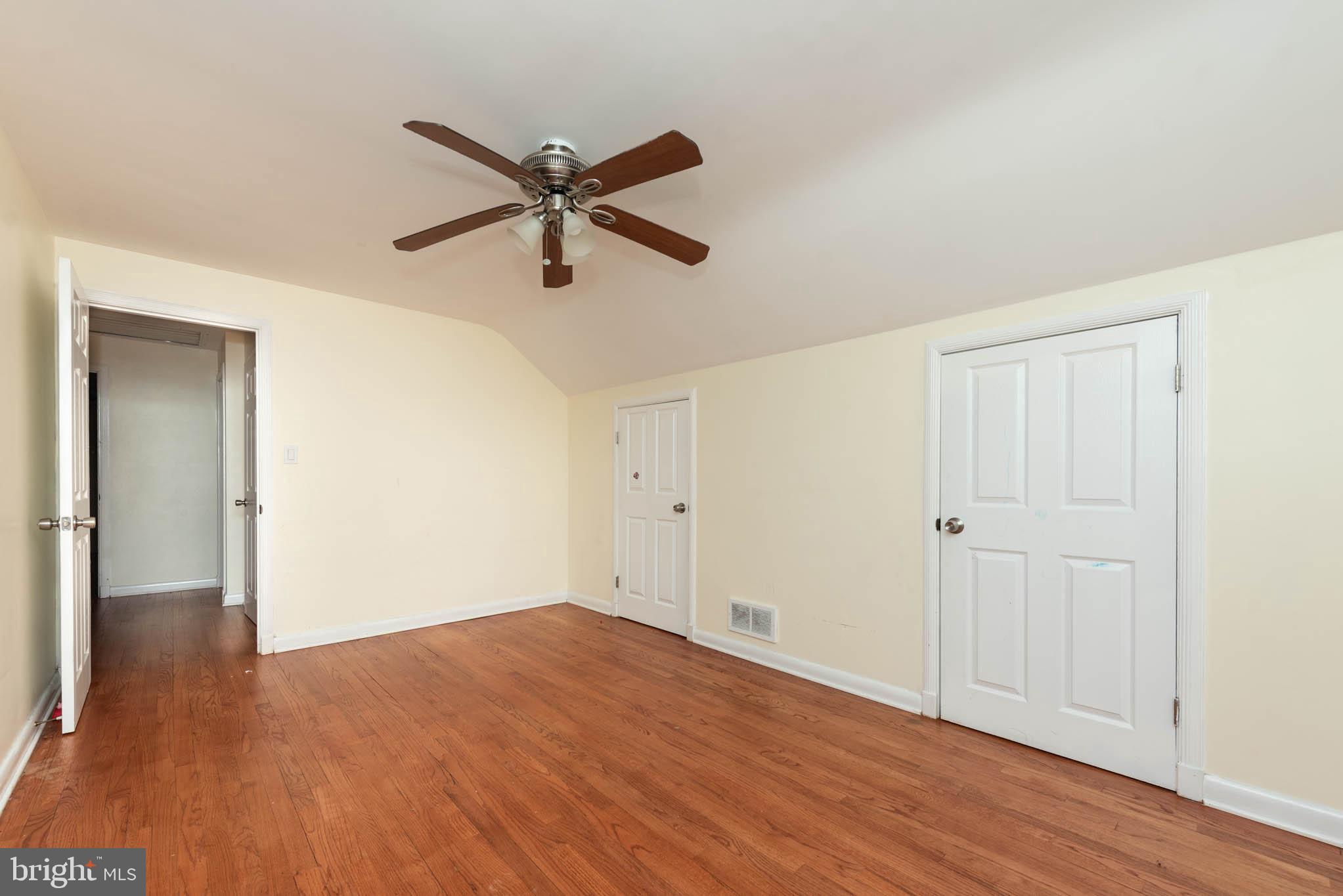 6702 Queens Ferry Road Baltimore, MD 21239 - Photo 22 of 40 a view of a big room with wooden floor and windows in a room
