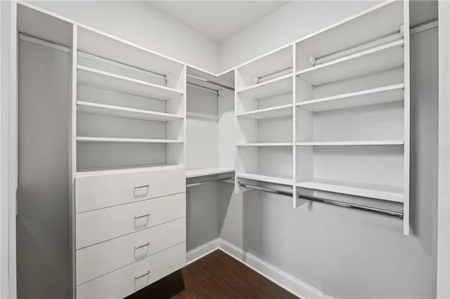 a spacious bedroom with a bed and a large window