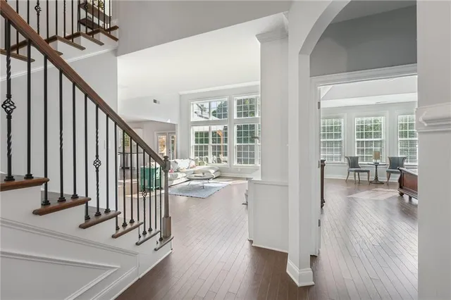a view of a hallway with wooden floor and stairs