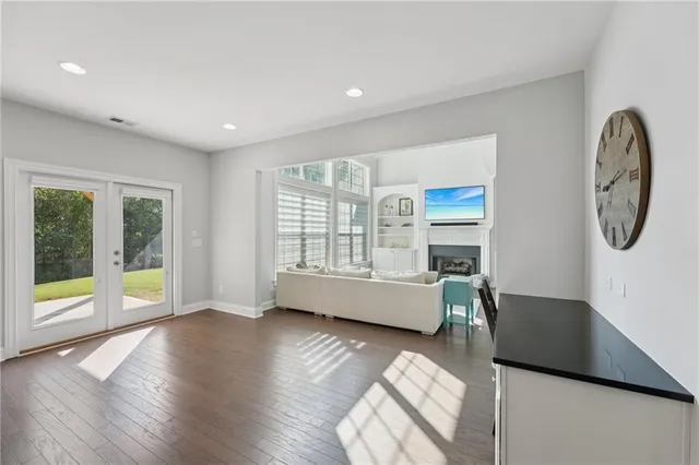 a view of workspace with wooden floor and windows