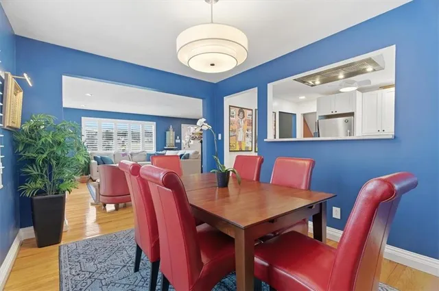 a view of a dining room with furniture window and wooden floor