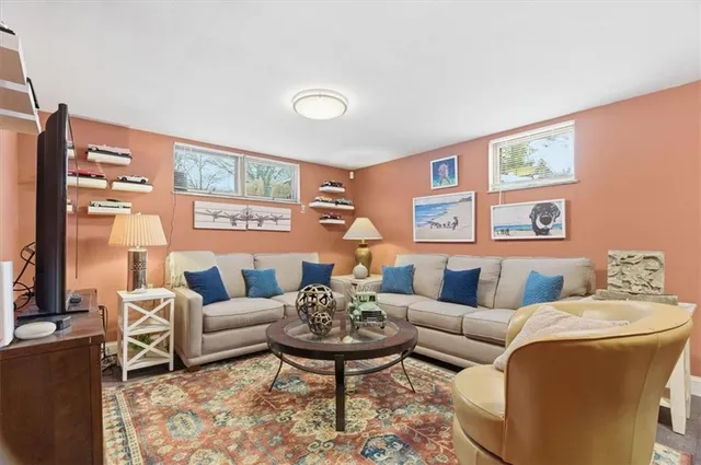 a living room with furniture a rug and a large window