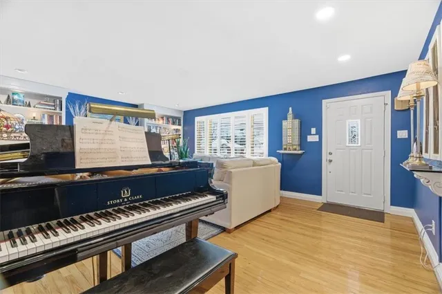 a living room with furniture and a piano