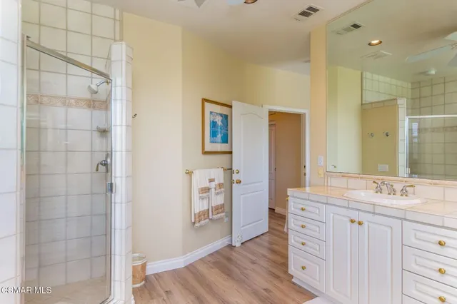 a vase of flowers sitting on a floor