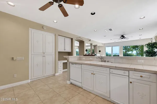 a storage room with wooden floor washer and dryer