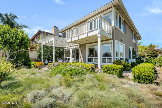 an empty room with wooden floor ceiling fan and windows