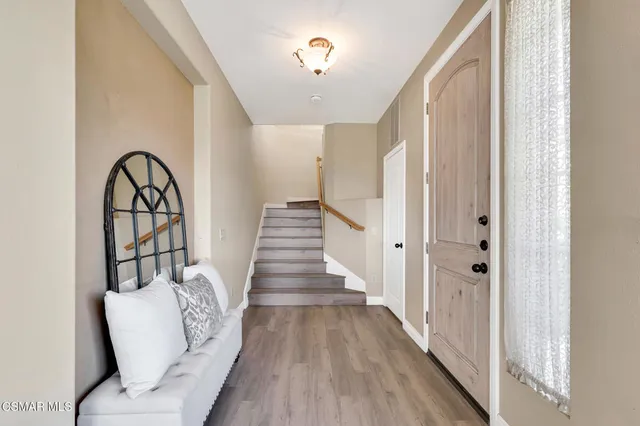 a view of closet area with wooden floor