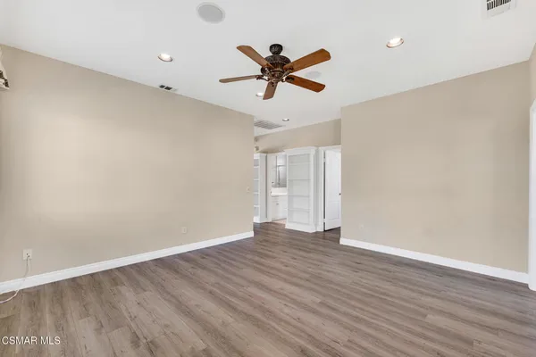 a view of a wooden balcony with lake view and boat