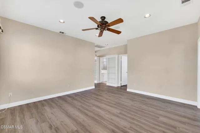 a view of a wooden balcony with lake view and boat