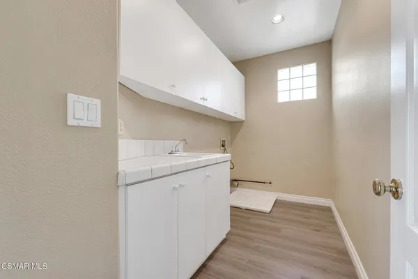 a bathroom with a granite countertop sink mirror and shower