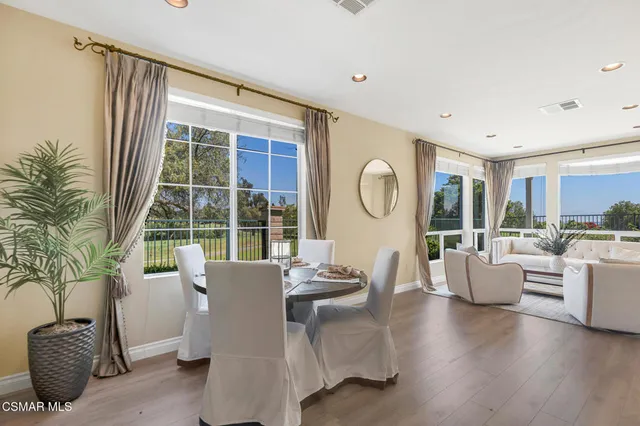 a view of a room with furniture and wooden floor