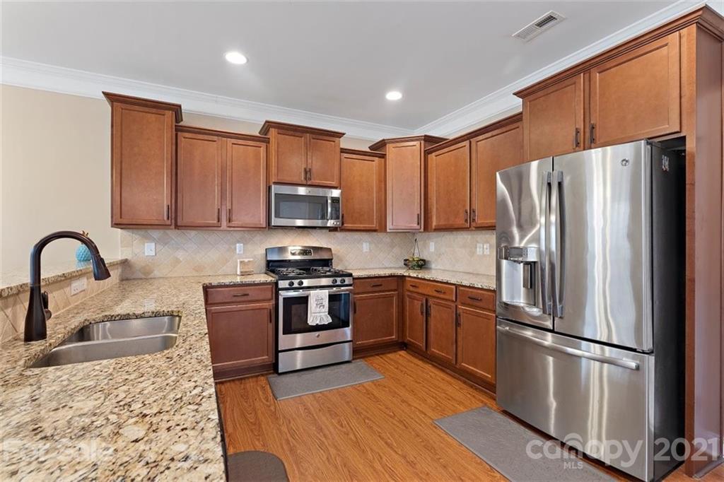 78150 Rillstone Drive Lancaster, SC 29720 - Photo 12 of 41 a kitchen with stainless steel appliances granite countertop a refrigerator stove microwave and sink