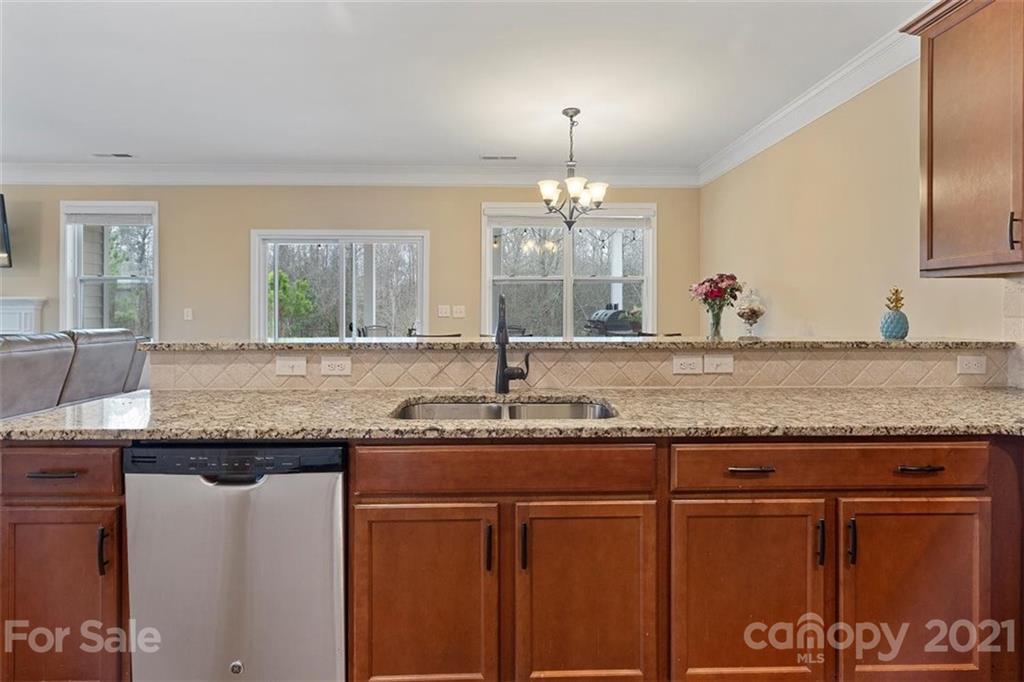 78150 Rillstone Drive Lancaster, SC 29720 - Photo 13 of 41 a kitchen with granite countertop a sink and a wooden cabinets