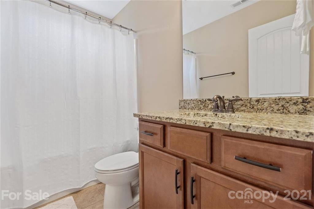 78150 Rillstone Drive Lancaster, SC 29720 - Photo 26 of 41 a bathroom with a granite countertop sink toilet and shower
