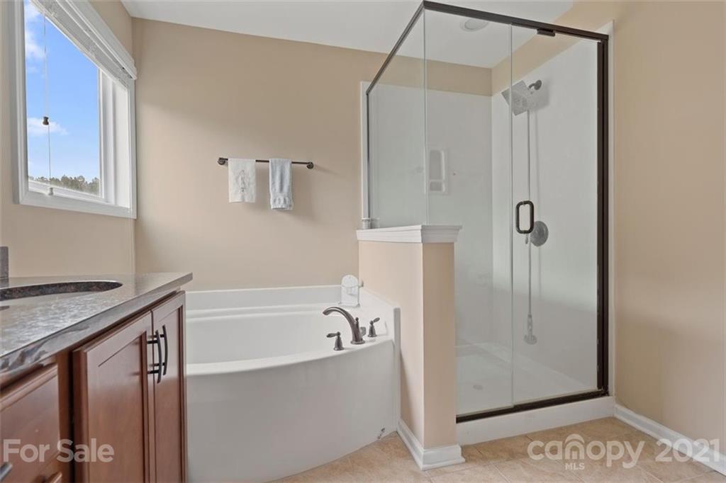 78150 Rillstone Drive Lancaster, SC 29720 - Photo 30 of 41 a bathroom with a bathtub and a shower