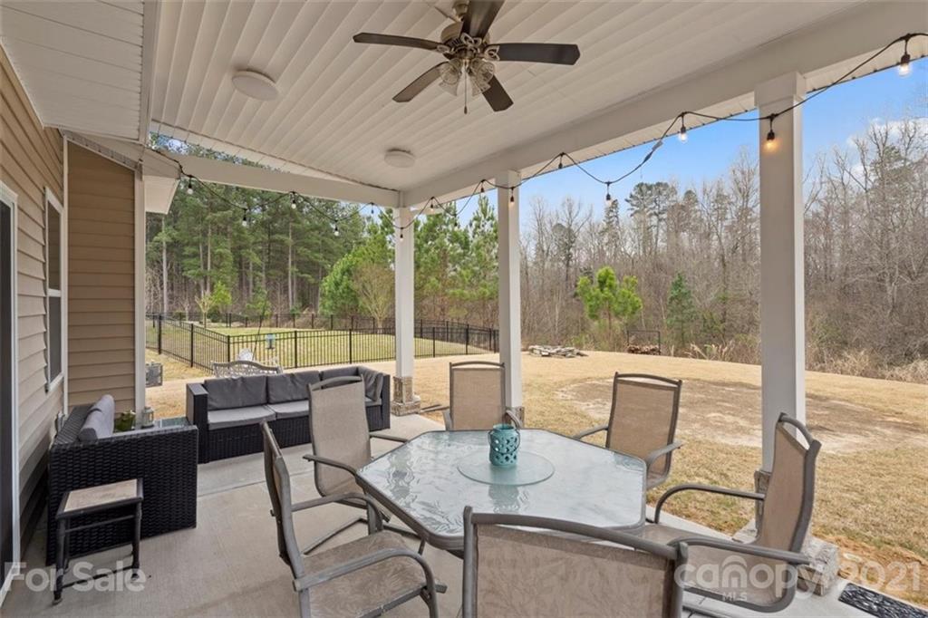 78150 Rillstone Drive Lancaster, SC 29720 - Photo 35 of 41 a dining room with furniture large windows and wooden floor