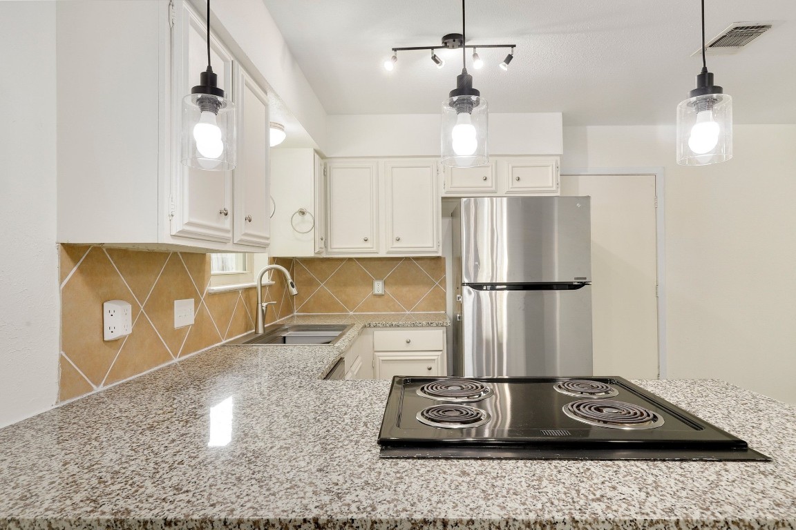 1008 Ridgeline Drive Round Rock, TX 78664 - Photo 11 of 30 a kitchen with sink refrigerator and window