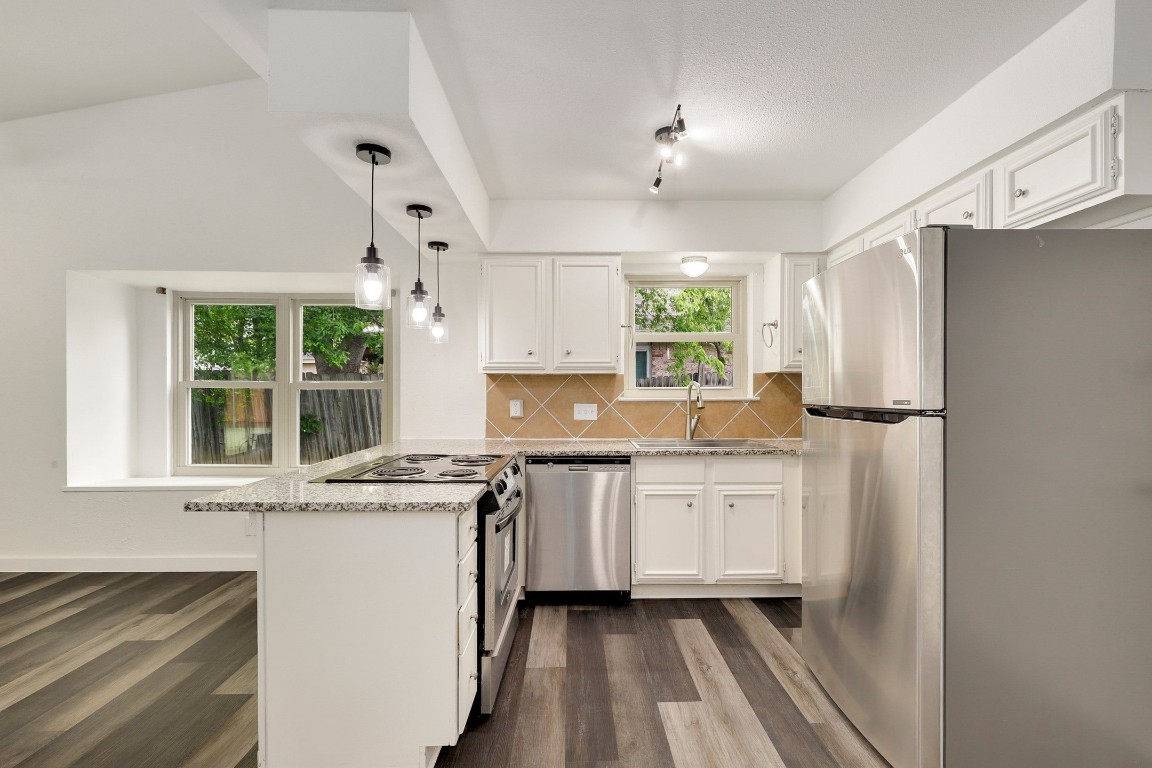 1008 Ridgeline Drive Round Rock, TX 78664 - Photo 12 of 30 a kitchen with a refrigerator a sink and cabinets