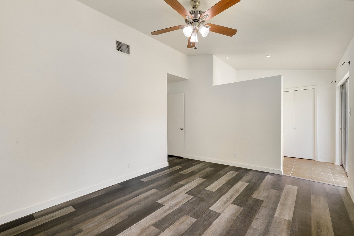 1008 Ridgeline Drive Round Rock, TX 78664 - Photo 18 of 30 an empty room with wooden floor chandelier fan and closet area