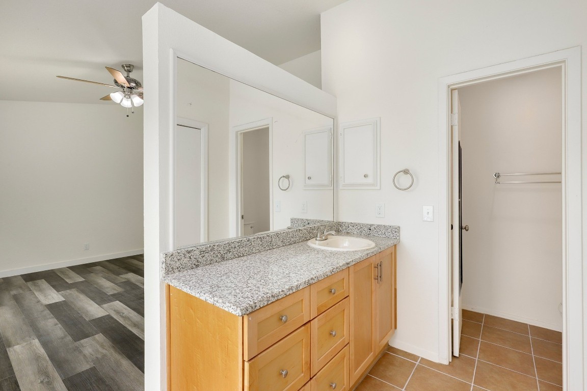 1008 Ridgeline Drive Round Rock, TX 78664 - Photo 21 of 30 a bathroom with a granite countertop sink and a mirror