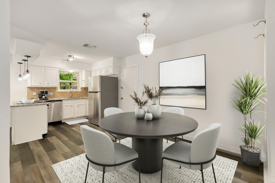 1008 Ridgeline Drive Round Rock, TX 78664 - Photo 8 of 30 a kitchen with stainless steel appliances kitchen island granite countertop a dining table and chairs