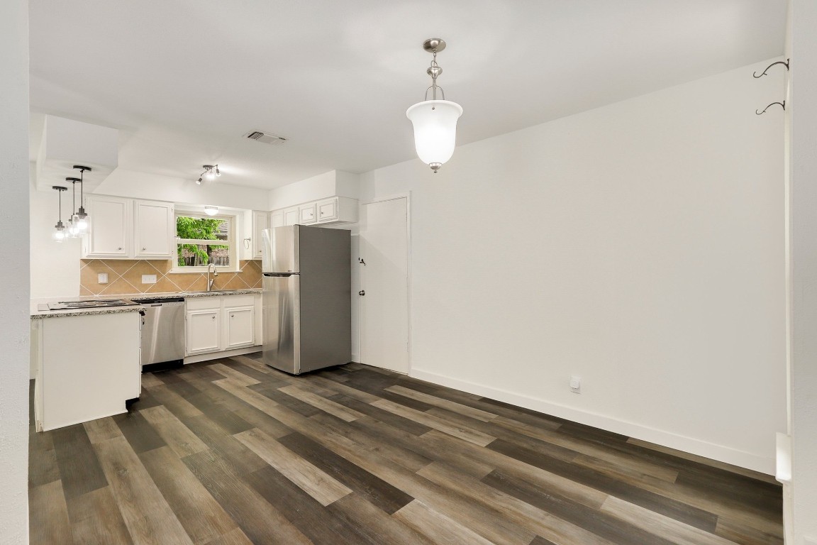 1008 Ridgeline Drive Round Rock, TX 78664 - Photo 9 of 30 a kitchen with a refrigerator and microwave