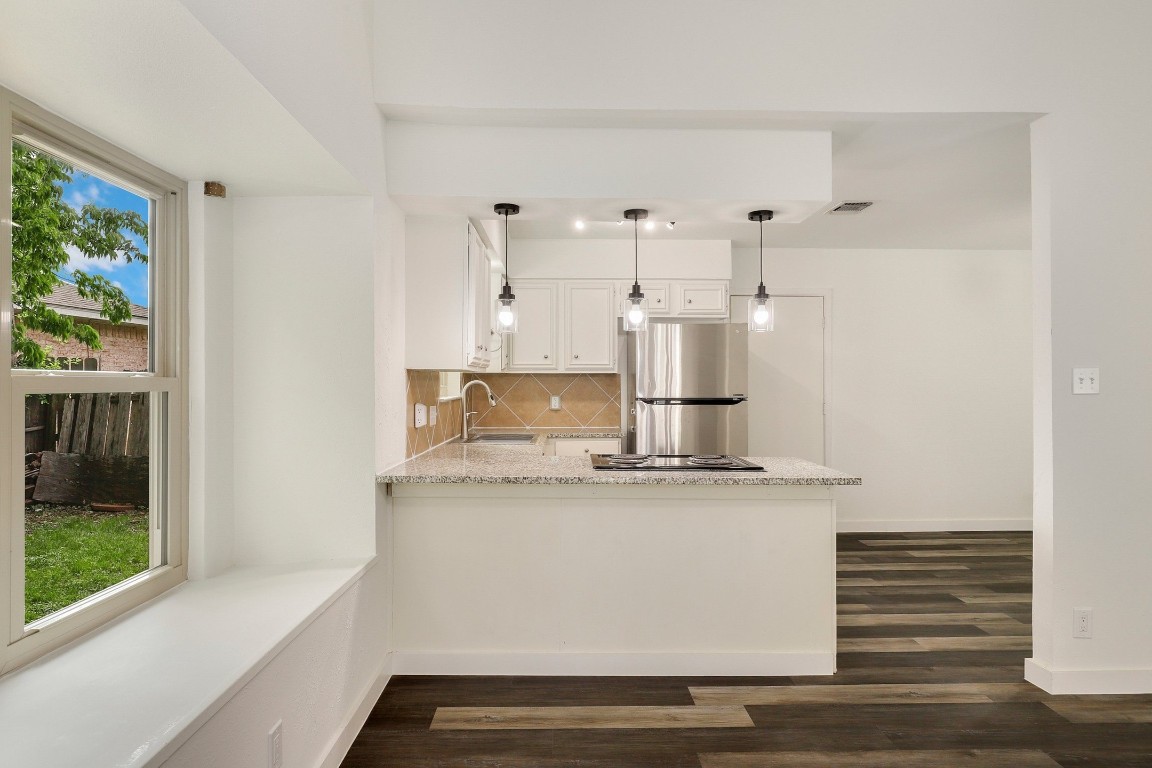 1008 Ridgeline Drive Round Rock, TX 78664 - Photo 10 of 30 a view of kitchen with stainless steel appliances granite countertop cabinets and a wooden floor
