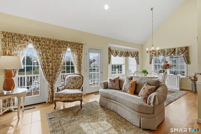 a living room with furniture and a floor to ceiling window