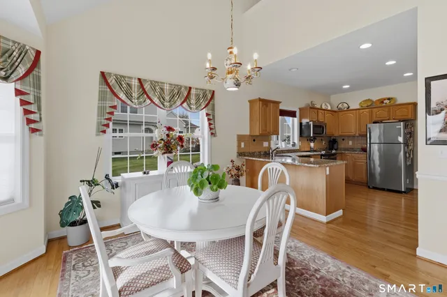 a view of a dining room with furniture and wooden floor
