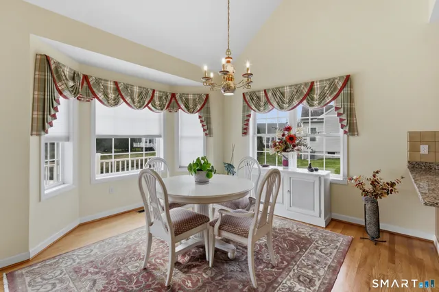 a view of a dining room with furniture window and wooden floor