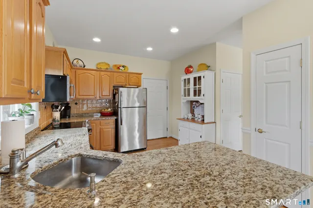 a kitchen with a refrigerator and a sink