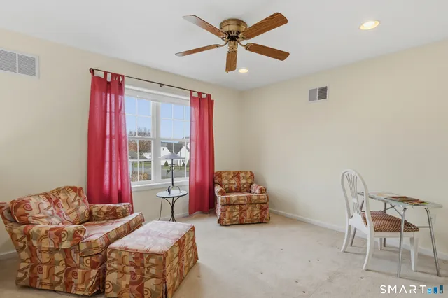 a bedroom with furniture and a large window