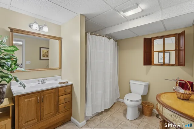 a bathroom with a sink toilet and mirror