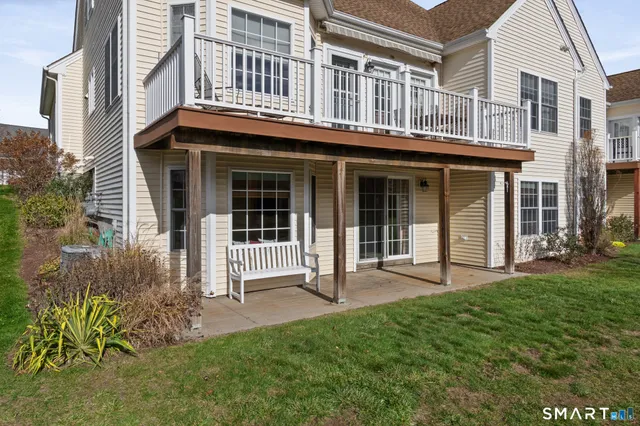 a view of a house with brick walls and a yard with plants