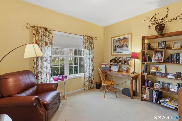 a living room with furniture and book shelf