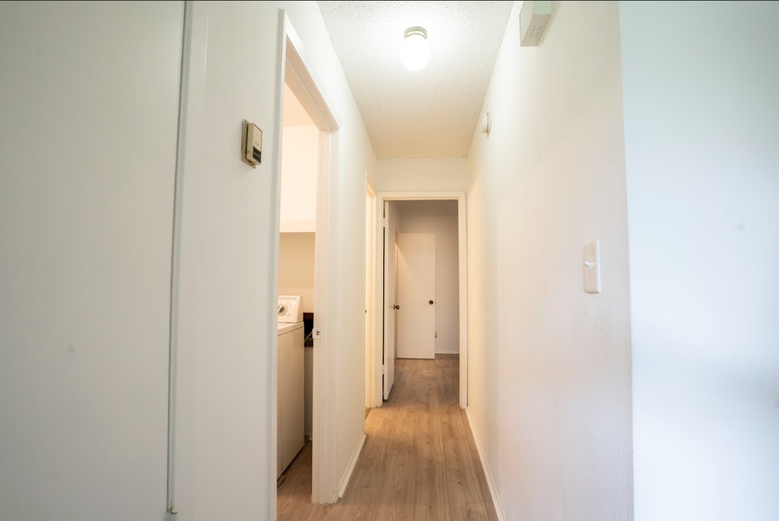 906 Silver Quail Lane Austin, TX 78758 - Photo 17 of 33 Corridor featuring light wood-style floors and washer / clothes dryer
