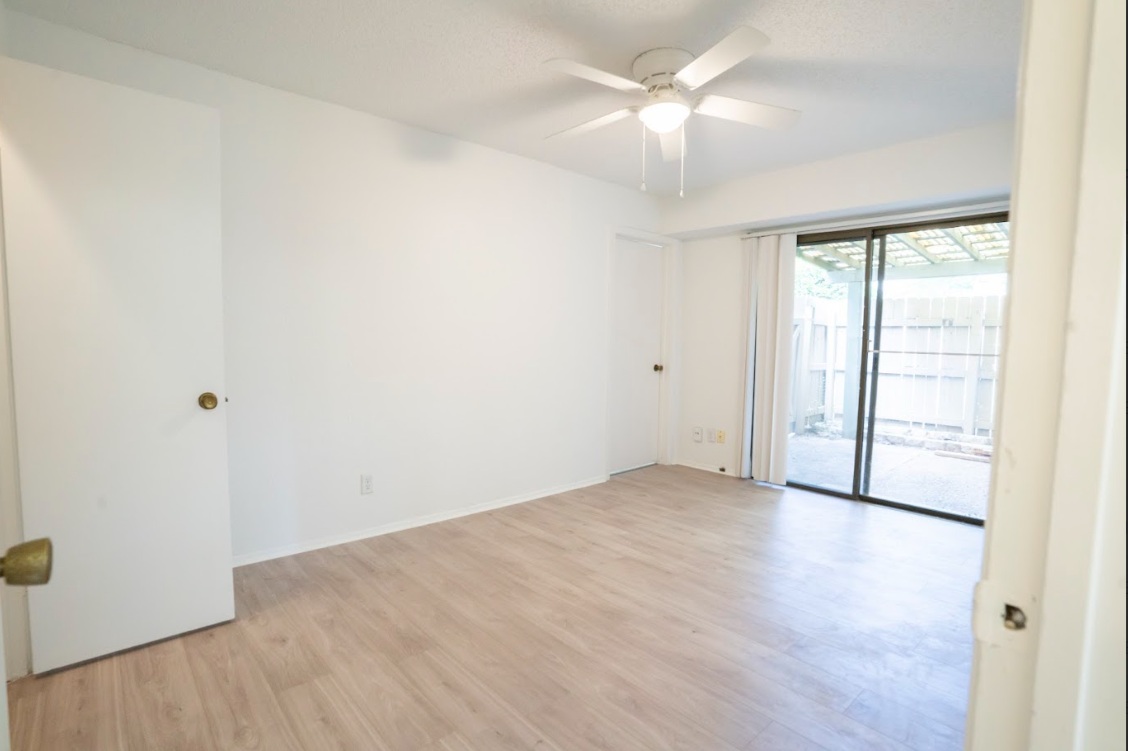 906 Silver Quail Lane Austin, TX 78758 - Photo 19 of 33 Unfurnished room with light wood-type flooring and ceiling fan