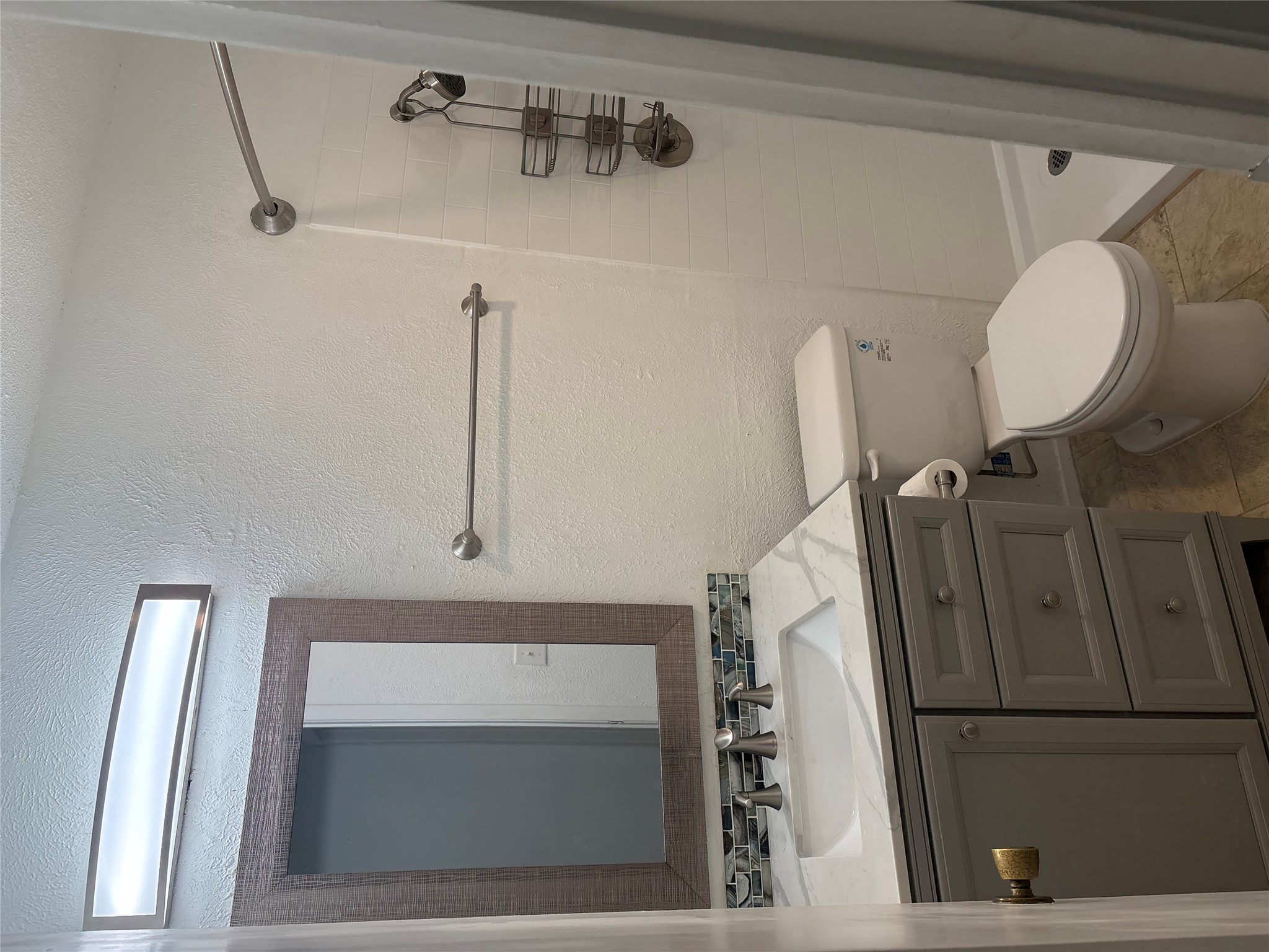 906 Silver Quail Lane Austin, TX 78758 - Photo 24 of 33 Bathroom with vanity, a shower stall, and a textured wall
