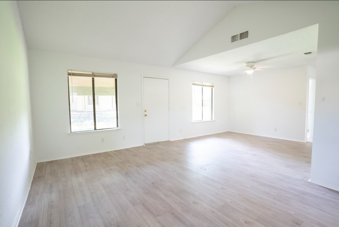 906 Silver Quail Lane Austin, TX 78758 - Photo 7 of 33 Empty room with light wood-type flooring, high vaulted ceiling, and a ceiling fan