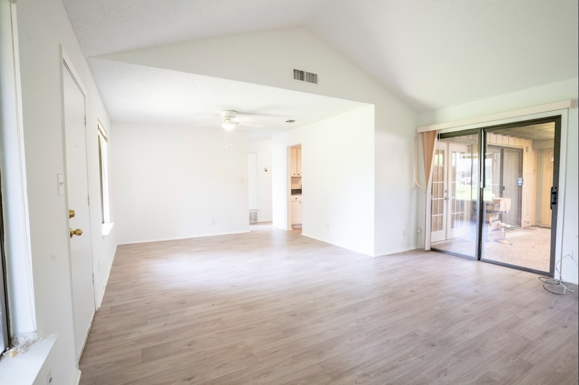 906 Silver Quail Lane Austin, TX 78758 - Photo 8 of 33 Unfurnished room featuring light wood-style floors, lofted ceiling, and a ceiling fan