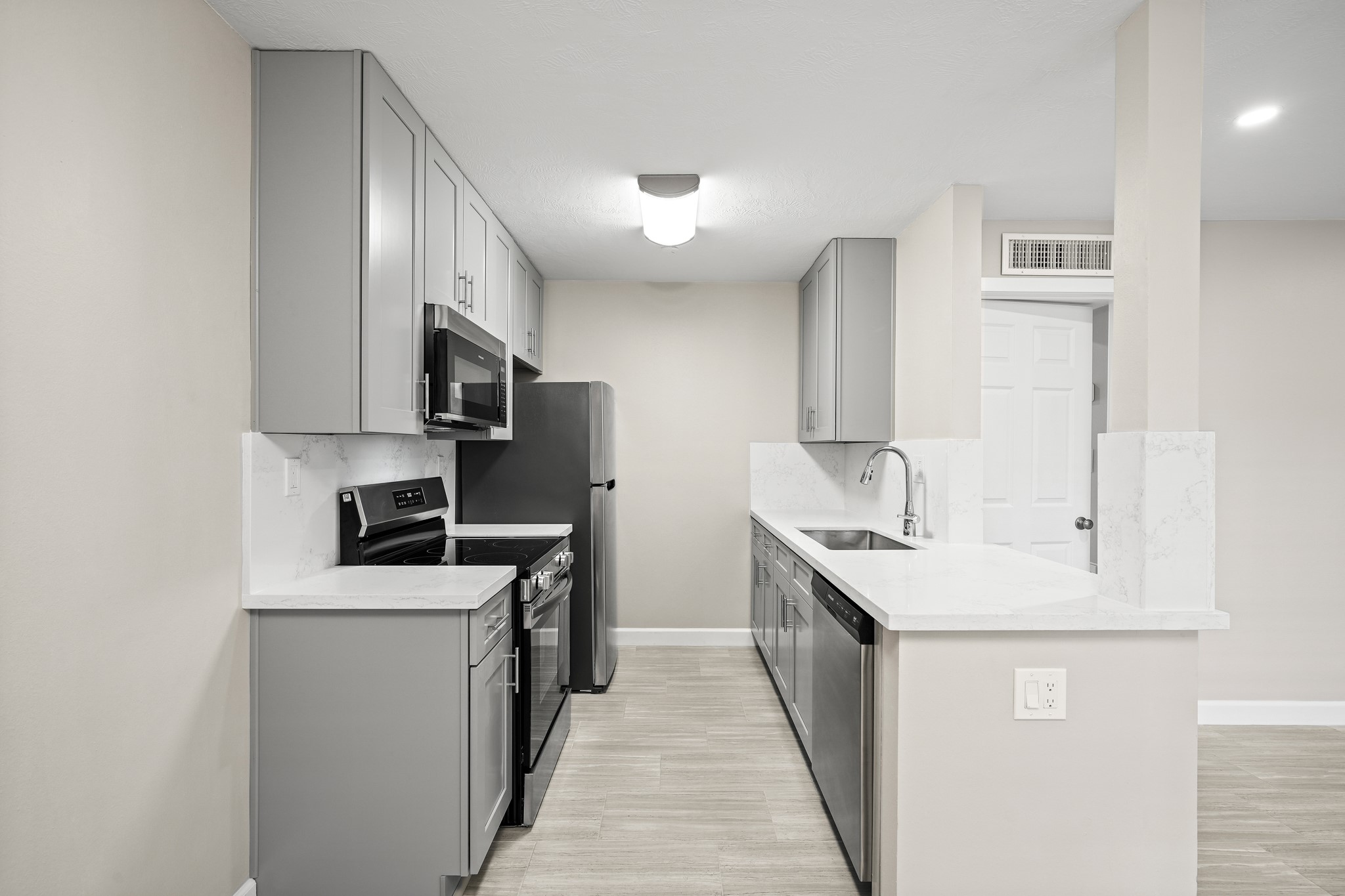 a kitchen with stainless steel appliances a sink stove and cabinets