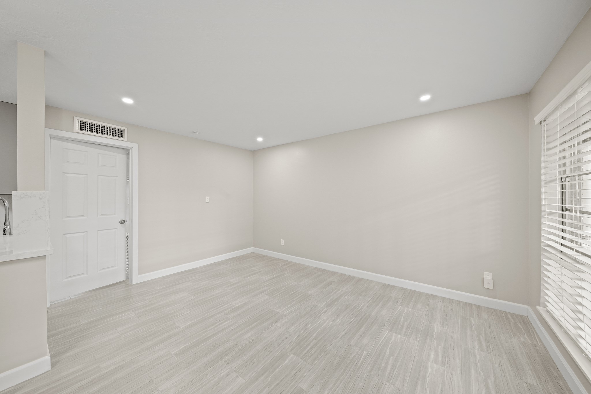 2201 Fountain View Drive, Unit 25 Houston, TX 77057 - Photo 4 of 12 wooden floor in an empty room with a window