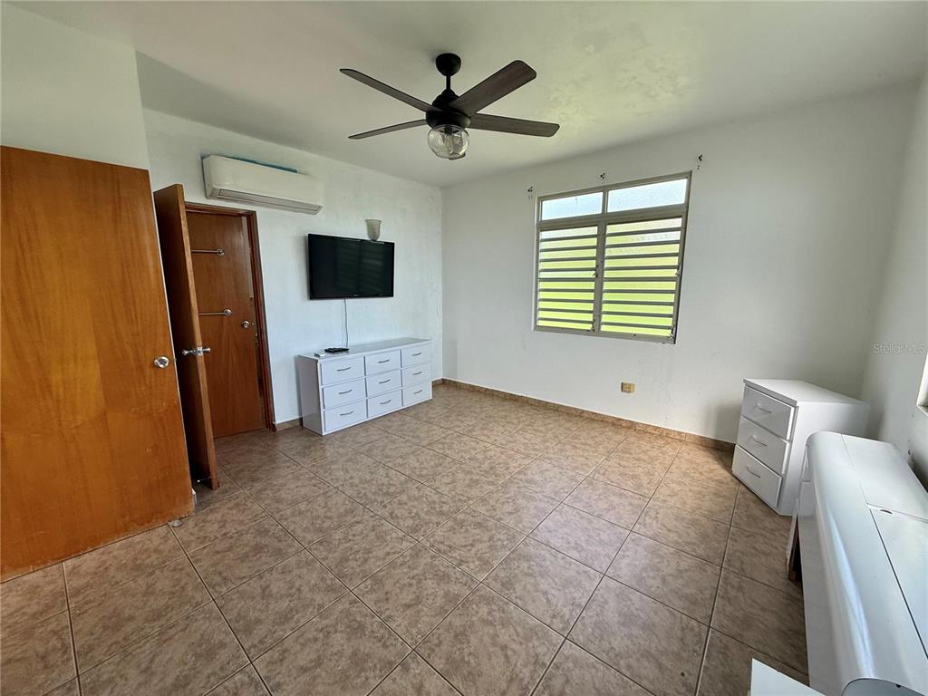 411 Bo Calvache Rincon, PR 00677 - Photo 5 of 14 a living room with furniture and a flat screen tv