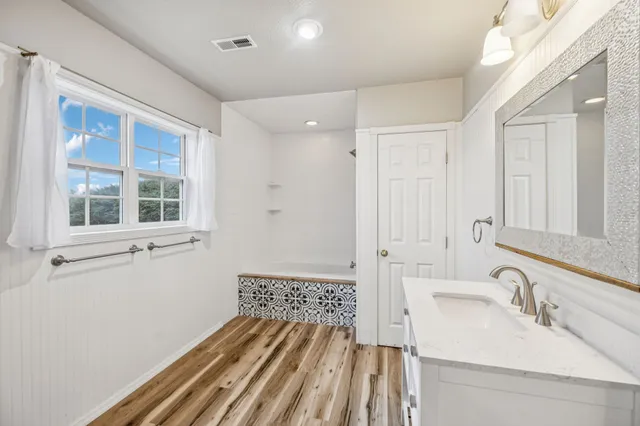 a living room with a bed and a large window
