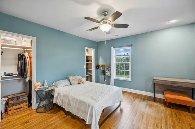 a spacious bedroom with a bed and a fireplace