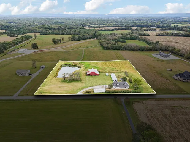 a kitchen with stainless steel appliances granite countertop a stove top oven a sink and a dining table with kitchen island