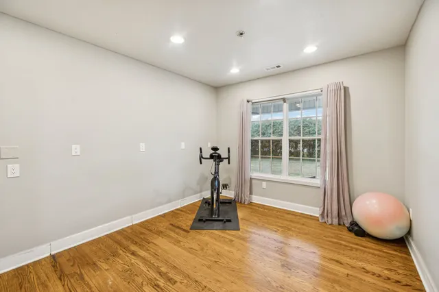 a view of a lake with a yard and large trees