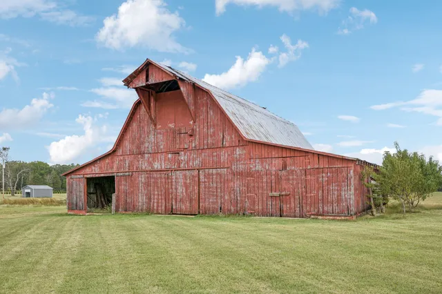 a large kitchen with stainless steel appliances granite countertop a lot of counter space and wooden floors