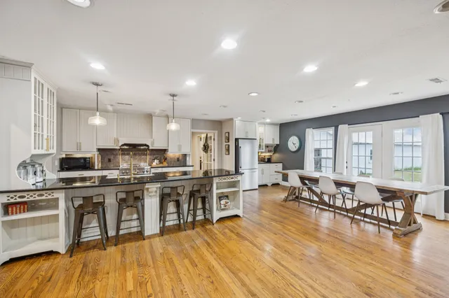a bedroom with a large bed and a chandelier